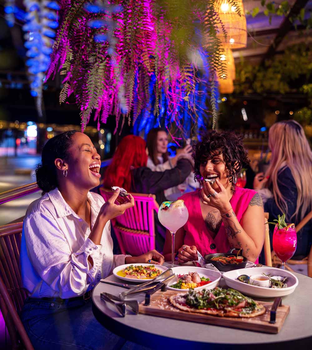 the lights of Vivid Sydney surrounding diners eating outside