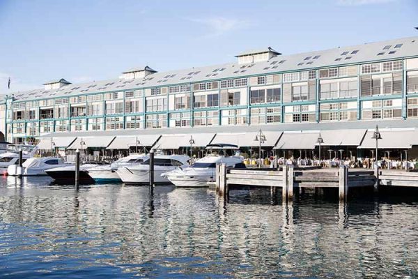 Boats moored at the infamous Woolloomooloo Wharf where restaurants line the waters edge