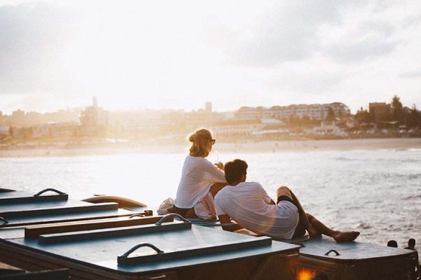 A couple overlooking Bondi Beach at sunset