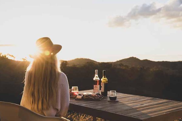 A woman wine tasting with views of the Hunter Valley