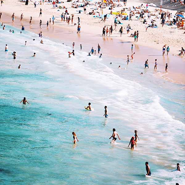 beach goers in the surf at Bondi Beach